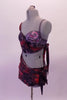 Two-piece costume has a purple, red and grey marbled sarong style half top and skirt as the base. The top crosses over the right bust with silver accents and wraps asymmetrically and ties up at the left back. The left bust reveals a beautiful hand painted purple-grey bra, Left side