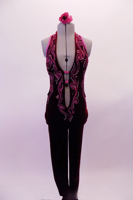 Deep burgundy velvet halter unitard has a deep open front held together by two centre straps just below the bust. The front is intricately decorated by hand painted designs in pink & purple surrounded with crystal accents. The open sides & back are piped in pink. Comes with a floral hair accessory. Front
