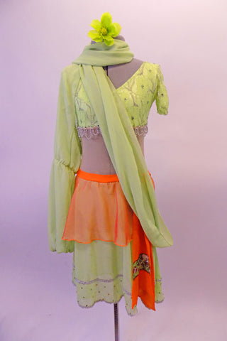 3-piece costume has a traditional taste of India with a Bollywood feel. Pale green beaded lace covered half-top has cap sleeves & beaded scallop trim. It is complemented by a single Bishop-sleeved half-shrug that extends into a long wrap scarf. The matching skirt has orange peplum overskirt with a beaded kerchief. Front