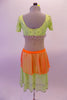 3-piece costume has a traditional taste of India with a Bollywood feel. Pale green beaded lace covered half-top has cap sleeves & beaded scallop trim. It is complemented by a single Bishop-sleeved half-shrug that extends into a long wrap scarf. The matching skirt has orange peplum overskirt with a beaded kerchief. Back