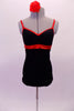 Black leotard has a built-in bra and sides that open to the back. It has bright red metallic binding and straps. Comes with a red floral hair accessory. Front