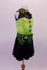 Back and lime green sequined costume has faux sweetheart bust with a black mesh upper and a green and black polka dot collar that matches the waistband and large bow accent. The back is open with corset style straps that hold the torso together. The attached black skirt completes the look. Comes with polka dot gauntlet and hair accessory. Side