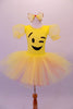 Yellow pleated ballet dress has sheer pouffe sleeves and a large emoji-style happy face on the torso with a crystal-edged neckline. The tutu skirt is yellow with a layer of pale pink beneath. Comes with large yellow hair bow accessory. Front