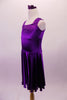 Stretch satin tank style purple dress has a wide shoulder strap. The bodice has a series of colour matched crystals in a large triangular shape and along the straps. Comes with matching floral hair accessory. Side
