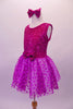 Magenta dress has sequined tank style bodice with scoop back. The skirt is sheer polka dot tulle and has a bow accent at the front centre of the waistband. Comes with matching sequined hair bow. Side