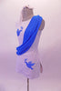 Short white tunic dress has hand-painted blue doves with an olive branch in the right bust and left hip. A blue sash cascades from left shoulder, across the torso to the right hip. Comes with white brief and hair accessory. Left side
