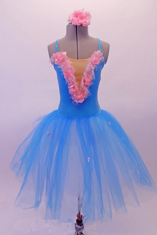 Turquoise romantic tutu dress has velvet bodice with cross back straps and a deep V front with nude inlay lined with pink silk rosettes and flower petals. The skirt has scattered tiny pink rosettes that match the bodice. Comes with matching pink floral hair accessory. Front