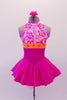 Halter style princess cut hot pink dress has a white, orange & pink floral bodice. The bright orange banding below bustline has a floral design set in crystals & extends around to the open back. The bottom is hot pink with a large orange bow at the back. Comes with a pink floral hair accessory. Front