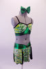 Green Yellow & silver crackle pattern two-piece costume has a crop top with bra-like inlay over shiny green with black piping & crystal accents. The matching skirt has a wide shiny green waistband that gathers at front centre and spliced panels of colour and black that create the actual skirt. Comes with green hair bow. Side