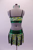 Green Yellow & silver crackle pattern two-piece costume has a crop top with bra-like inlay over shiny green with black piping & crystal accents. The matching skirt has a wide shiny green waistband that gathers at front centre and spliced panels of colour and black that create the actual skirt. Comes with green hair bow. Back