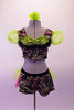 Two-piece costume dazzles with a silver-pink & green abstract leafy glitter design on black velvet. The top has line green organza pouffe sleeves & a green pure sequined pop-out bust edged in black lace ruffle. The matching shorts have a back bustle in lime green & hot pink organza. Comes with green hair flower. Front