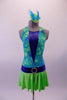 Turquoise, lime green & royal blue dress has a halter neckline with tie-dye pattern and  deep-V royal blue inlay lined with crystals at front. The attached skirt is lime green with royal blue waistband & crystal belt buckle accent. Comes with lime green crystalled gauntlets with blue banding & matching hair accessory. Front