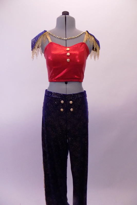 Marching band themed royal blue gold glitter pants have four gold button accents at the front. The accompanying red half-top has gold straps & three gold buttons at the front. Two large blue-gold epaulettes grace the shoulders edged with gold fringe. A gold beaded chain cascades from shoulder to shoulder on the chest. Front