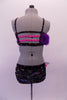 2-piece costume is attached by two crystal covered straps that extend from below the left bust across the front of the torso. The costume is a black base with colourful holographic dotted pattern. The brief has crystalled waistband & an orange-pink tulle accent at hip & the bust of the purple fur covered strappy bra. Back