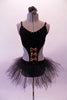 Black velvet camisole leotard dress has large cut-out side and is edged with topaz crystals. The front center of the torso has three shiny bronze bow accents. The attached tulle tutu style skirt gives the costume a quirky style. Comes with a black floral hair accessory. Front