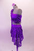 2-piece purple costume has a single shoulder half top with long lace sleeve. The right shoulder has an epaulette with purple morning glory flowers & dangling sequins. A purple sequined scarf drapes from right shoulder to below the left bust. Double-sided short-long lace sarong style skirt wraps around the hips. Left side