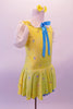 Yellow dress with floral sequin pattern has pouffe sleeves and a white eyelet lace Peter Pan collar. A turquoise ribbon tie highlights the front center at the collar. The attached blue sequin edged petticoat give the dress some volume. Comes with a yellow floral hair accessory. Side