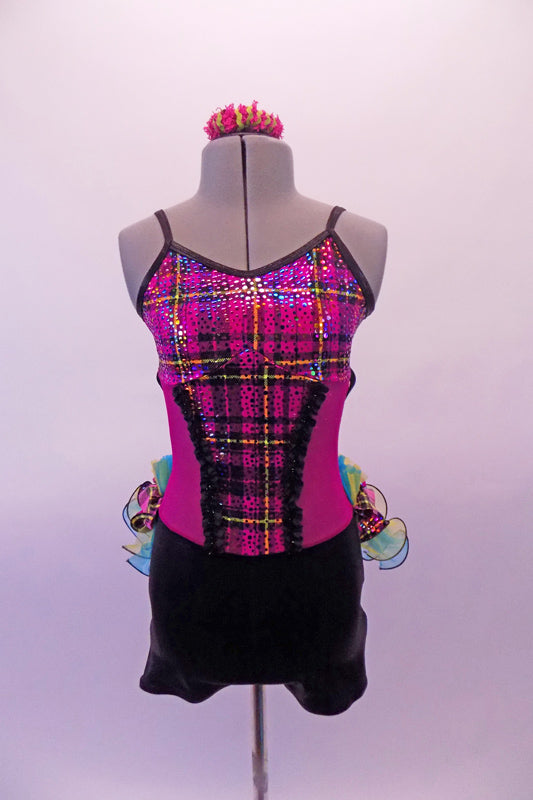 Short unitard has a black bottom and the top is fuchsia with a colourful tartan bust and torso section edged with black lace. The attached back bustle is comprised of layers of yellow and turquoise organza curly ruffle and layers of gathered tartan and organza. Comes with matching hair accessory.  Front