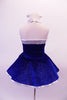 Royal blue glitter velvet halter dress has shimmery white satin trims. The sweetheart neckline is lined with crystals, as is the wider band below the bustline complete with large white bow accent. The attached white petticoat gives the skirt the poufy volume. Comes with short white satin gloves and matching hair bow. Back