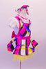 Colourful dress with abstract geometric patterns of blue pink yellow & black has a white ruffled collar & pouffe sleeves on a faux white blouse with keyhole back. The dress has hot pink crystalled piping & large pink bow at the back. The yellow tulle petticoat gives the skirt some volume. Comes with matching hair bow. Side