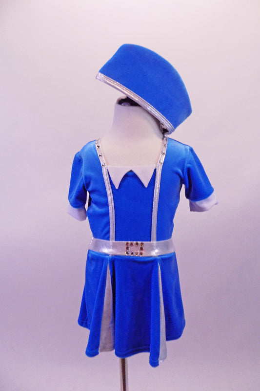 Flight attendant style costume is a short-sleeved bright blue velvet with silver banding, waistband and pleats. The deep V back is held by a horizontal crystalled strap.  Comes with a matching blue velvet attendant hat. Front