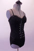 Black boned, zip back, Guess bustier has delicate sequined ruffle along the bustline and down the front center of the hook and eye bustier with crystal accents. The matching Lacey Swimmer brief is a higher cut with leatherette side panels. Comes with a black floral hair accessory. Side