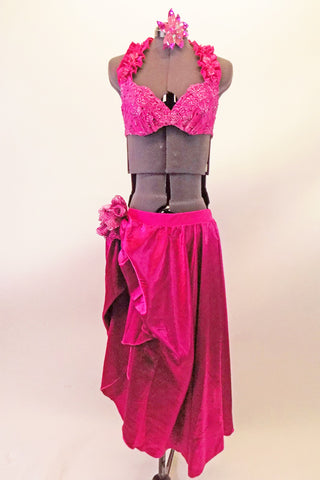 2-piece fuchsia costume has an underwire, halter style bra. The bra has embroidered lace & crystal covered cups with ruffled neck straps and triple crystal covered back straps. The sateen skirt with attached brief opens & gathers up the right side, with a lace floral accent. Comes with sequined hair accessory. Front