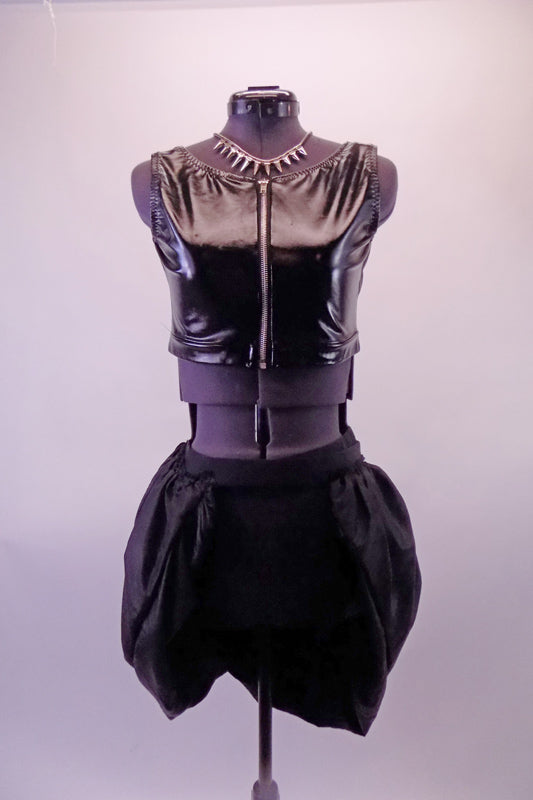 Black leatherette vest/half-top has a zip front. The bottom is shorts with an attached overlapping bubble pouffe bustle skirt. Comes with a spiked necklace accessory. Front