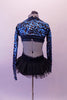 Black and teal glittery leotard dress has crossover front halter neckline and open back edged with crystals. The attached open-front, black tutu bustle skirt gives a bit of flare.  The teal and black, sequined shrug completes the look. Comes with a black floral hair accessory. Back
