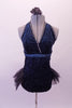 Black and teal glittery leotard dress has crossover front halter neckline and open back edged with crystals. The attached open-front, black tutu bustle skirt gives a bit of flare.  The teal and black, sequined shrug completes the look. Comes with a black floral hair accessory. Front without bolero
