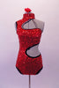 Spunky bright red sequined leotard has open left shoulder and side with swirled-circular design edged in black and lined entirely in Swarovski crystals. The asymmetrical back has a single crystal covered strap. Comes with a floral hair accessory. Front