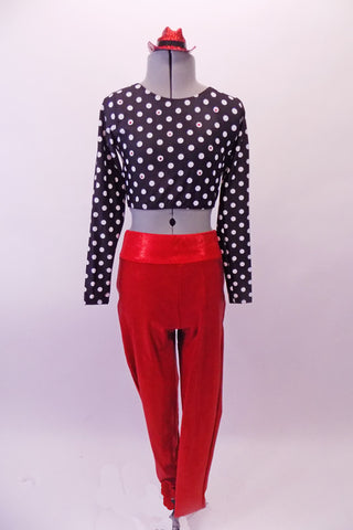 Bright red shiny leggings have large black crystalled back pockets to add some pizzazz. The black and white polka dot half-top has round scoop-neck front, long sleeves and wide bands that cross-over to create the back. Comes with glittery red hat accessory. Front