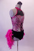 Fuchsia and black leotard has a pink animal print torso with faux corset detail and sweetheart bust lined entirely with crystals. The upper chest is a sheer black mesh with fuchsia collar.  The bustle gives the costume its biggest pop. It is comprised of layers of hot pink boa feathers. Comes with a floral hair accessory. Side