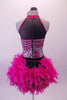 Fuchsia and black leotard has a pink animal print torso with faux corset detail and sweetheart bust lined entirely with crystals. The upper chest is a sheer black mesh with fuchsia collar.  The bustle gives the costume its biggest pop. It is comprised of layers of hot pink boa feathers. Comes with a floral hair accessory. Back