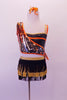 Three-piece costume has a black and gold layered fringed skirt with gold waistband and attached brief. The black half-top with orange and gold piping accent and double shoulder straps sits beneath a single shoulder orange and gold sequined shrug with orange edging. Comes with a gold and orange hair accessory. Front