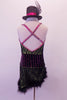 Green based dress had a black lace overlay. The wide black velvet waistband has fuchsia pinstripes that compliment the fuchsia piping and cross back straps lined entirely with crystals. The angled skirt has a black marabou trim. Comes with mini black top hat accessory with a fuchsia band. Back