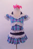 Plaid dress in shades of blue aqua and pink, has denim halter straps, waistband and crystalled faux boning accents. A wide white eyelet lace trim lines the off-shoulder top, pouffe sleeves, bust and waist. Comes with pink bow hair accessories. Front