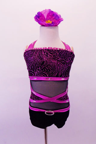 Sweet & classy short black unitard has purple band accents. The black velvet bust has purple sparkle swirl design & crystal-lined purple halter neck bands. The black sheer torso has crossed purple bands with velvet sides & crystal accents. The black velvet bottom finishes the outfit. Comes with a floral hair accessory. Front