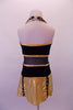 Black & gold dress is two pieces. The halter leotard has black velvet bust area edged with crystal covered gold piping, crystal brooch front accent & black sheer torso. The skirt bottom is a made of gold flaps with crystalled black edging. Comes with a black velvet bowler hat with gold band and crystal brooch accent. Back
