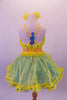 Costume has a pearl beaded sequined bodice with blue sequined yellow organza ruffle. The attached skirt has a double layer of turquoise & yellow with ruffled edge & sequined cross straps, Blue sequined musical note applique accents the front of the skirt & the back of the straps. Comes with yellow organza hair clips. Back