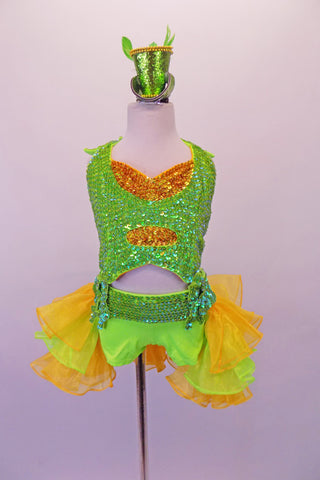 Two-piece costume is a pearl beaded sequined neon green halter half-top with gold sequined inlays. Matching green bottoms have a sequined waistband with money-symbol appliques at each hip. The open front bustle skirt is layers of green & yellow organza. Comes with matching wrist cuffs & mini green glitter top hat. Front