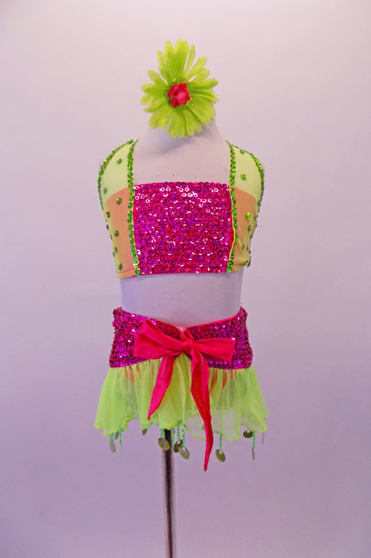 Fuchsia beaded sequin three-piece costume has bandeau style top with sheer pale green sequined sides that become the bands of the halter collar. The tie skirt is a wide beaded pink waistband with sheer pale green chiffon skirt that has green dangling circle sequins. Comes with green & pink floral hair accessory. Front