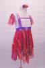 Cute dress has gold, lavender and fuchsia striped and layered kerchief skirt and sleeves. The torso is white sequined with a faux lavender pinafore accent. Comes with matching pom-pom hair accessory. Side