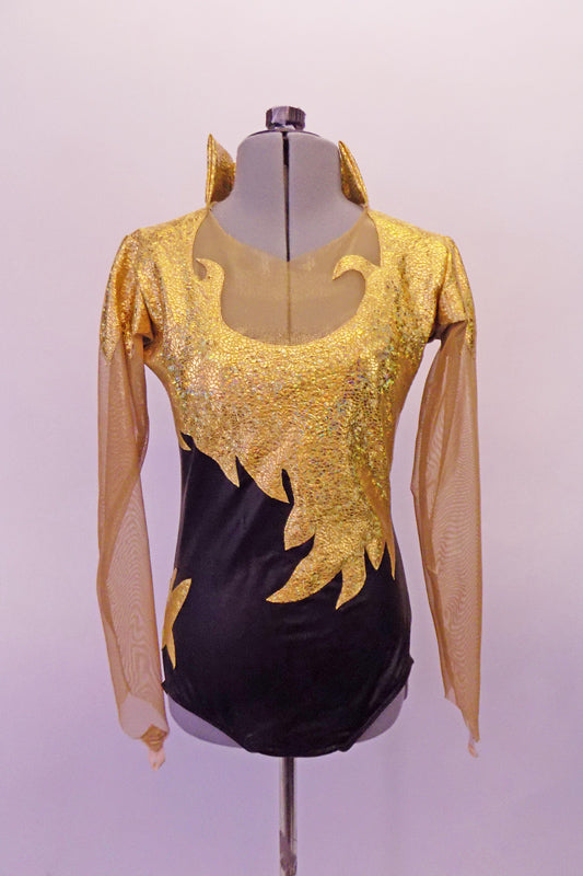 Black based leotard has gold front flame/scroll designed front torso & shoulders. The sleeves are a long nude mesh that attaches beneath the gold shoulders & high neck that opens at the front. The nude mesh also adorns the upper bust which keeps the design from curling and keeps it flat against the chest. Front