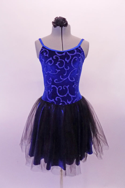 Pretty blue and black camisole dress has a blue velvet scroll pattern in the velvet. The attached blue shiny skirt has and sheer black tulle top layer that creates depth. The back is a lower scoop neck. Comes with a black floral hair accessory. Front