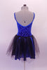 Pretty blue and black camisole dress has a blue velvet scroll pattern in the velvet. The attached blue shiny skirt has and sheer black tulle top layer that creates depth. The back is a lower scoop neck. Comes with a black floral hair accessory. Back