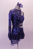 Blue costume is a two-piece joined at the left side of the waist. The base is a half top that gathers at the bust and shorts. The two pieces are attached via a sequined skirt that attaches to both the shorts and the shrug. The shrug is half sided, single sleeved and fully sequined which snaps at the side of the neck. Right side