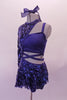 Blue costume is a two-piece joined at the left side of the waist. The base is a half top that gathers at the bust and shorts. The two pieces are attached via a sequined skirt that attaches to both the shorts and the shrug. The shrug is half sided, single sleeved and fully sequined which snaps at the side of the neck. Left side