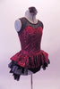Burgundy sequined leotard dress has black sheer mesh front upper with sweetheart neckline. The sequined peplum sits on top of the open front layered black petticoat skirt, Comes with a black floral hair accessory. Side