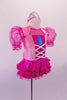 Pink and fuchsia dress has pink glitter velvet bodice with faux corset front and teardrop, pouffe organza fuchsia sleeves and ruffled sateen skirt. The keyhole back has a large white bow at the mid center of the back. Comes with a tiara hair accessory. Side